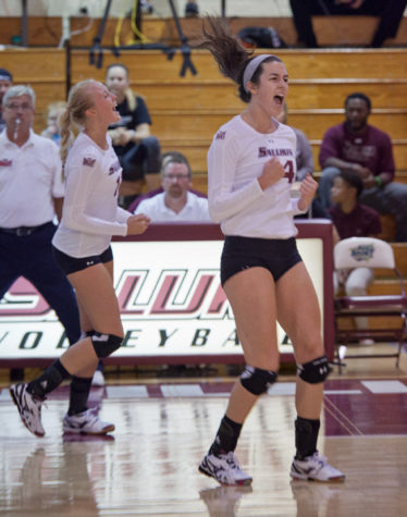 Nellie Fredriksson, left, and McKenzie Dorris celebrate after a point scored during Tuesday's game against SEMO. The Salukis defeated the Redhawks in three sets and improved to 7-3 this season. (DailyEgyptian.com file photo)