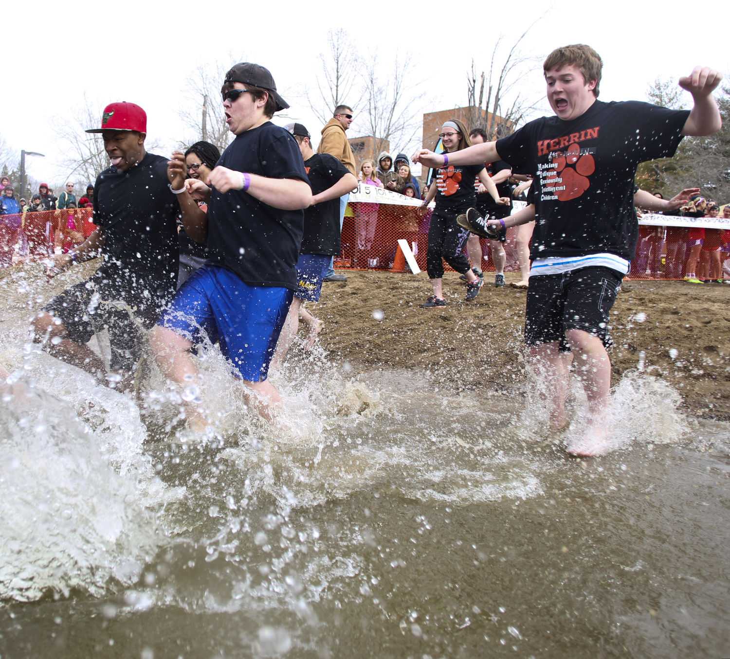 A group of students from Herrin run into Campus Lake on Saturday, Feb. 28, 2015 during the annual Polar Plunge. The event, which benefits the Special Olympics, raised $21,373.94 from 436 participants. (DailyEgyptian.com file photo)
