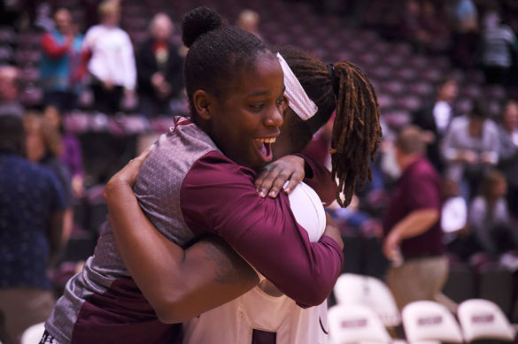 Point guard Rishonda Napier hugs then-senior forward/center Dyana Pierre after SIU’s 102-69 victory against Morehead State on Dec. 12 at SIU Arena. (DailyEgyptian.com file photo)