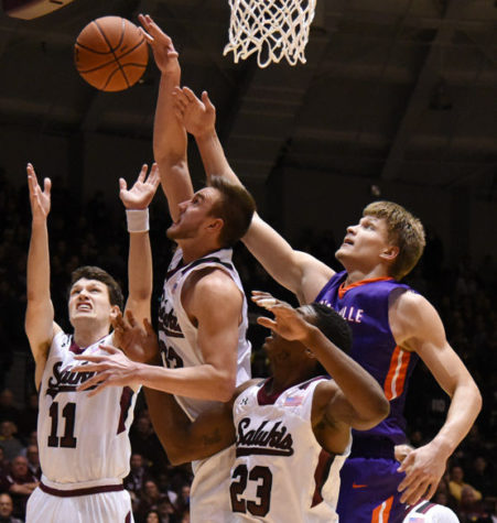 Left to right: Saluki guard Tyler Smithpeters, forward Sean O'Brien, center Bola Olaniyan and Evansville center Egidijus Mockevicius scramble for the ball during SIU’s 85-78 overtime loss the Evansville on Jan. 28 at SIU Arena. (Jacob Wiegand | @JacobWiegand_DE)