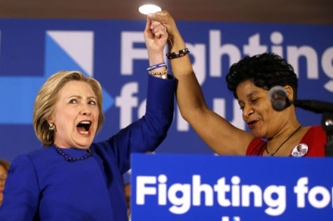 A spirited Democratic presidential candidate Hillary Clinton, left, joins Geneva Reed-Veal, the mother of Sandra Bland, during a campaign rally at the Parkway Ballroom on Chicago's South Side on Wednesday.