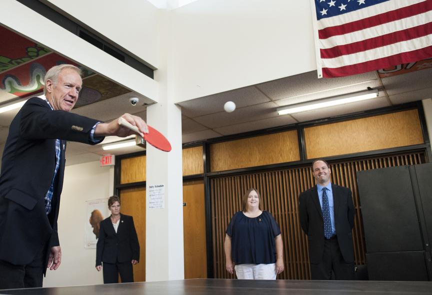 Gov. Bruce Rauner plays a round of pingpong Friday, Aug. 26, 2016, during his visit to Carbondale High School's Rebound program. (Ryan Michalesko | @photosbylesko)