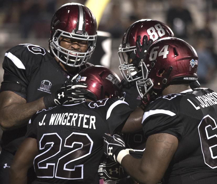Salukis celebrate a touchdown by junior running back Cameron Walter (22) during SIU's 50-17 win against Murray State on Saturday, Sept. 17, 2016, at Saluki Stadium. (Anna Spoerre | @annaspoerre)