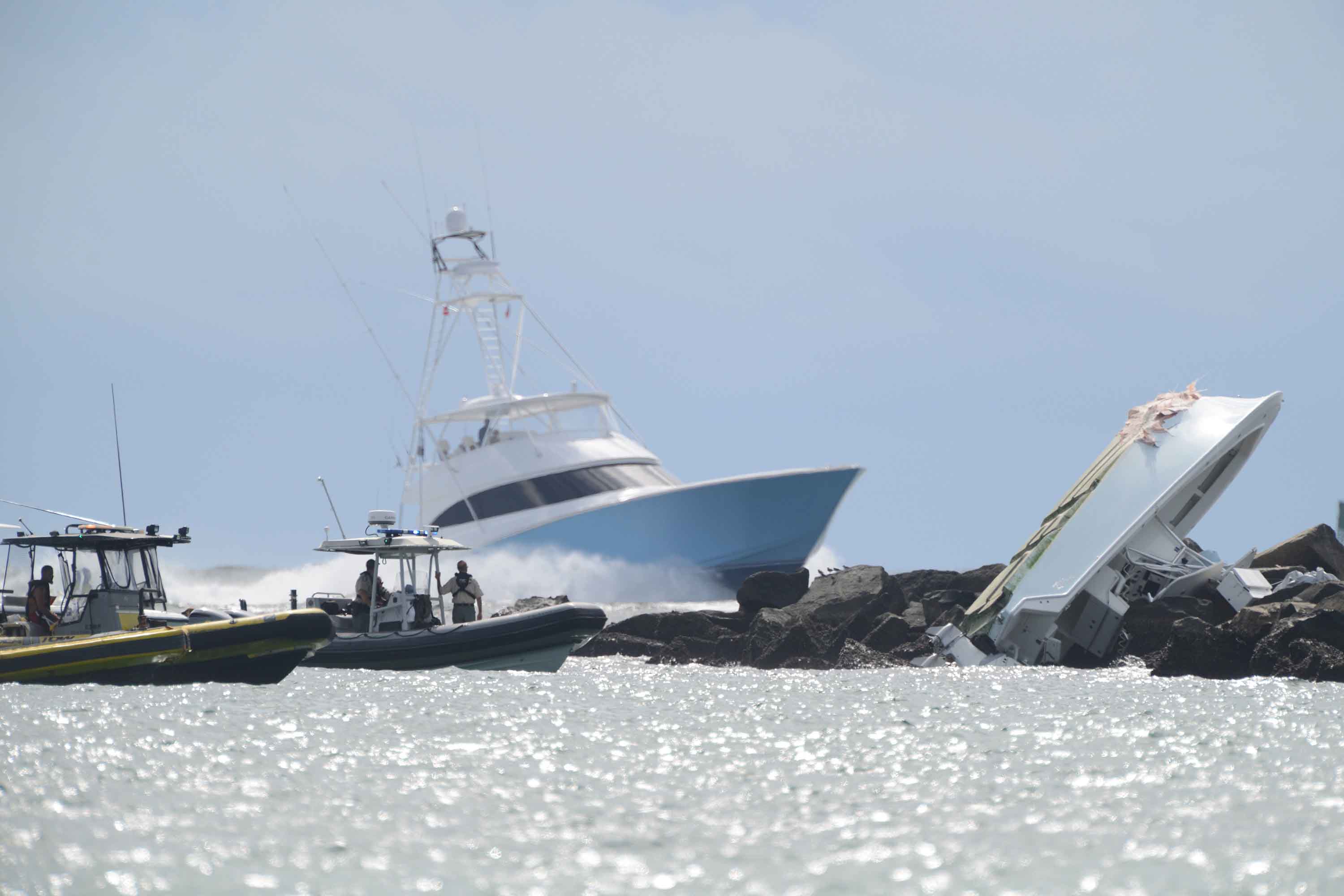 Investigators look over the overturned boat in which Miami Marlins pitcher Jose Fernandez was killed, Sunday, Sept. 25, 2016, in Maimi Beach. (Joe Caveretta/Sun Sentinel/TNS)