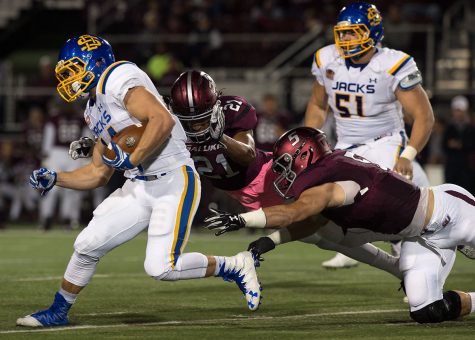 Jackrabbit junior running back Brady Mengarelli (44) is tackled by Saluki junior safety Ryan Neal (21) and senior inside linebacker Chase Allen (5) during the first half of the Salukis' 45-39 loss to South Dakota State on Saturday, Oct. 8, 2016, at Saluki Stadium. (Jacob Wiegand | @JacobWiegand_DE)