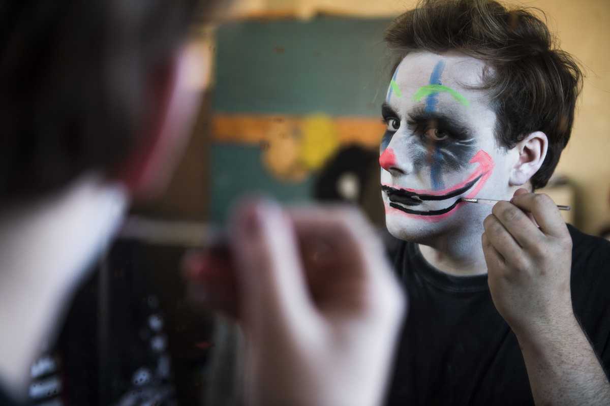 Patrick Burke, a junior from Los Angeles studying theater, applies costume makeup Sunday, Oct. 23, 2016, at Chittyville School Haunted House in Herrin. (Ryan Michalesko | @photosbylesko)