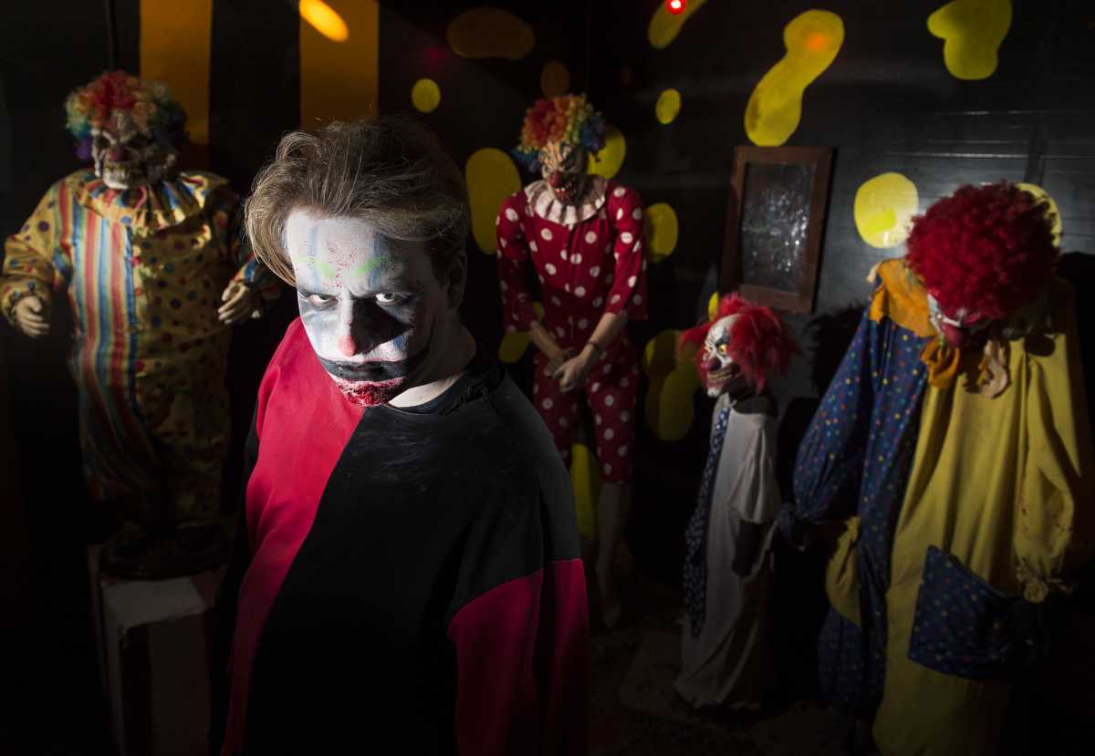 Patrick Burke, a junior from Los Angeles studying theater, poses for a portrait in the Clown Room on Sunday, Oct. 23, 2016, at Chittyville School Haunted House in Herrin. "It's fun scaring people," he said. (Ryan Michalesko | @photosbylesko)