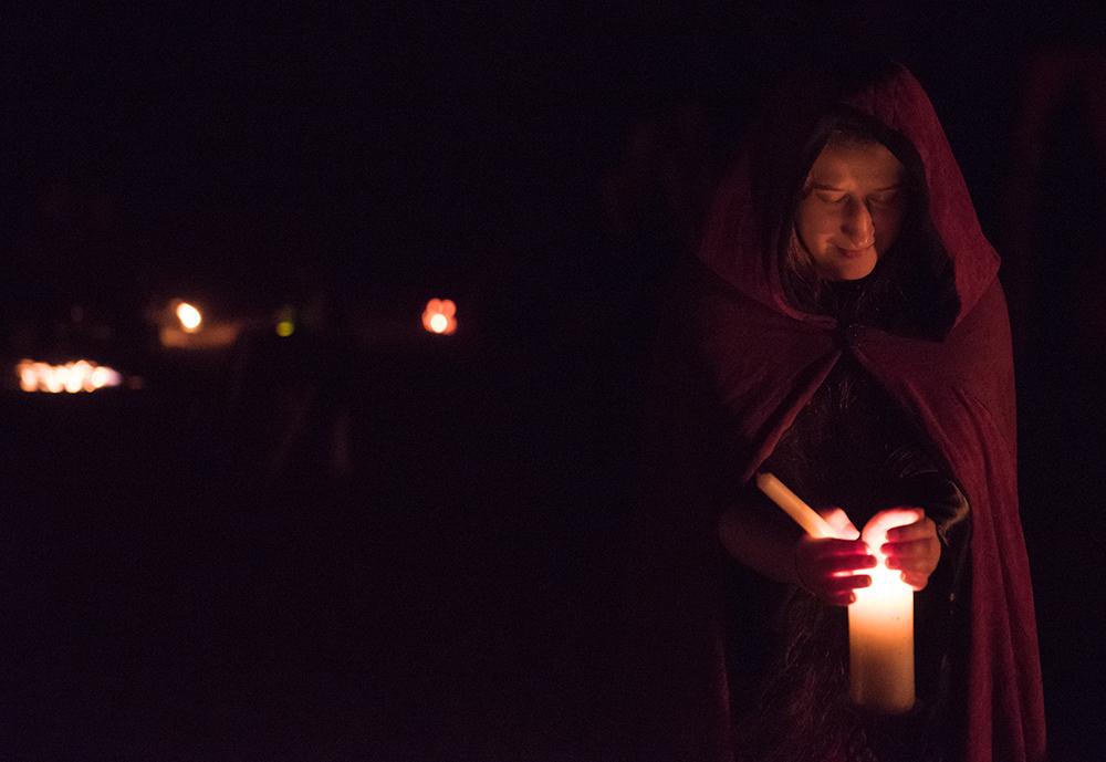 SIU alumna Brenna Carriger, of DeSoto, holds a keepsake at the ancestral altar Saturday, Oct. 29, 2016, during the Southern Illinois Pagan Alliance's Samhain celebration at Crab Orchard Lake. (Morgan Timms | @Morgan_Timms)