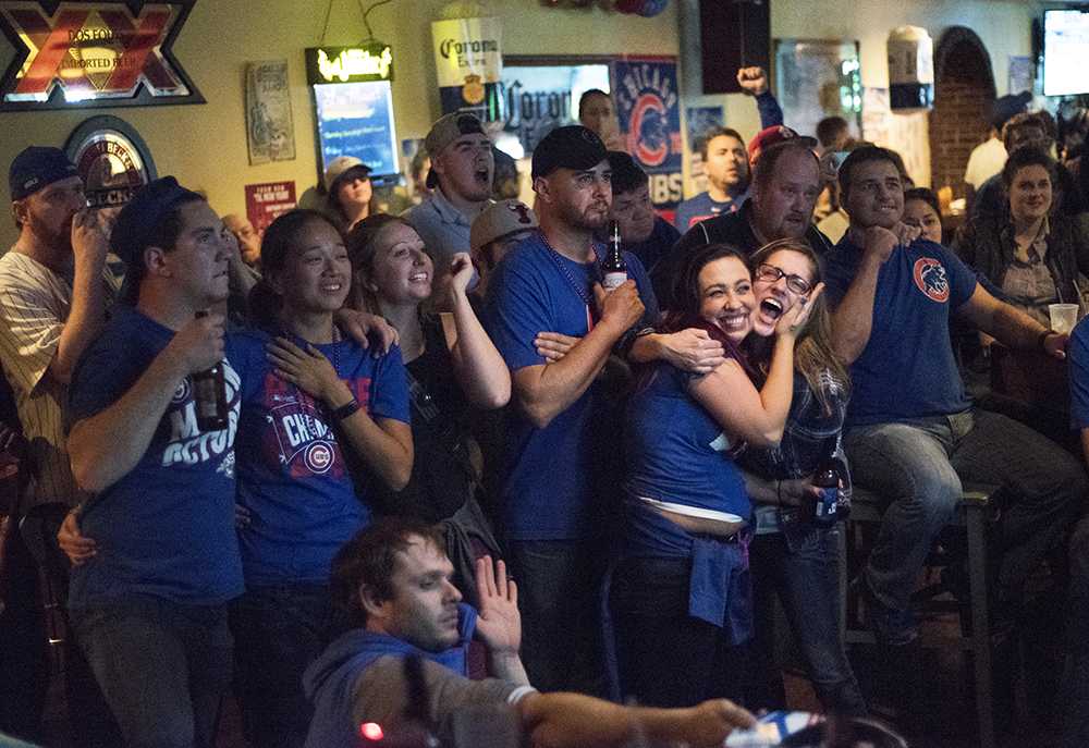 Cubs fans react to a play in the 10th and final inning of the Cubs' World Series-winning game against the Indians on Wednesday, Nov. 2, 2016, at Tres Hombres in Carbondale. The Cubs won the 2016 World Series 4-3, the team's first championships since 1908. 