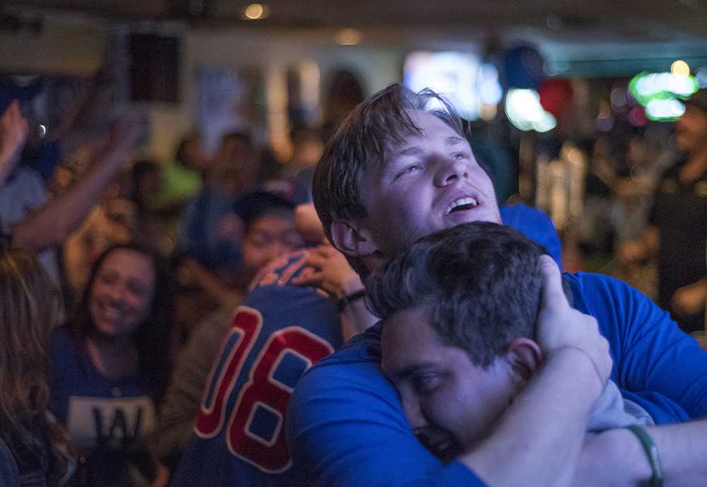 Tristan Workman, of Carbondale, embraces a friend Wednesday, Nov. 2, 2016, while celebrating the Cubs' 2016 World Series championship at Tres Hombres in Carbondale. The Northsiders won the Series 4-3. 