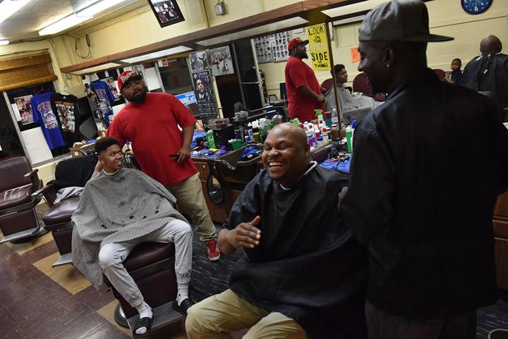 From left to right: DJ Hogan, a senior at Carbondale Community High School, Lee Hughes, Taliq Montegomery and Terrence Upchurch laugh together just before the shop closes up at 8 p.m. on Nov. 2, 2016. (Anna Spoerre | @annaspoerre)