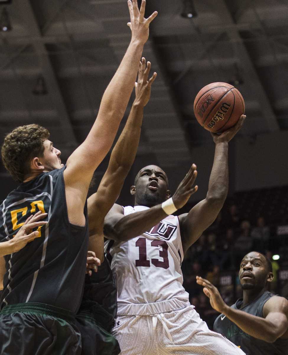 Sophomore guard Sean Lloyd fires up a shot past Missouri Southern freshman center Dexter Frisbie on Wednesday, Nov. 16, 2016, during the Salukis' 85-64 win over the Missouri Southern Lions at SIU Arena. (Ryan Michalesko | @photosbylesko)