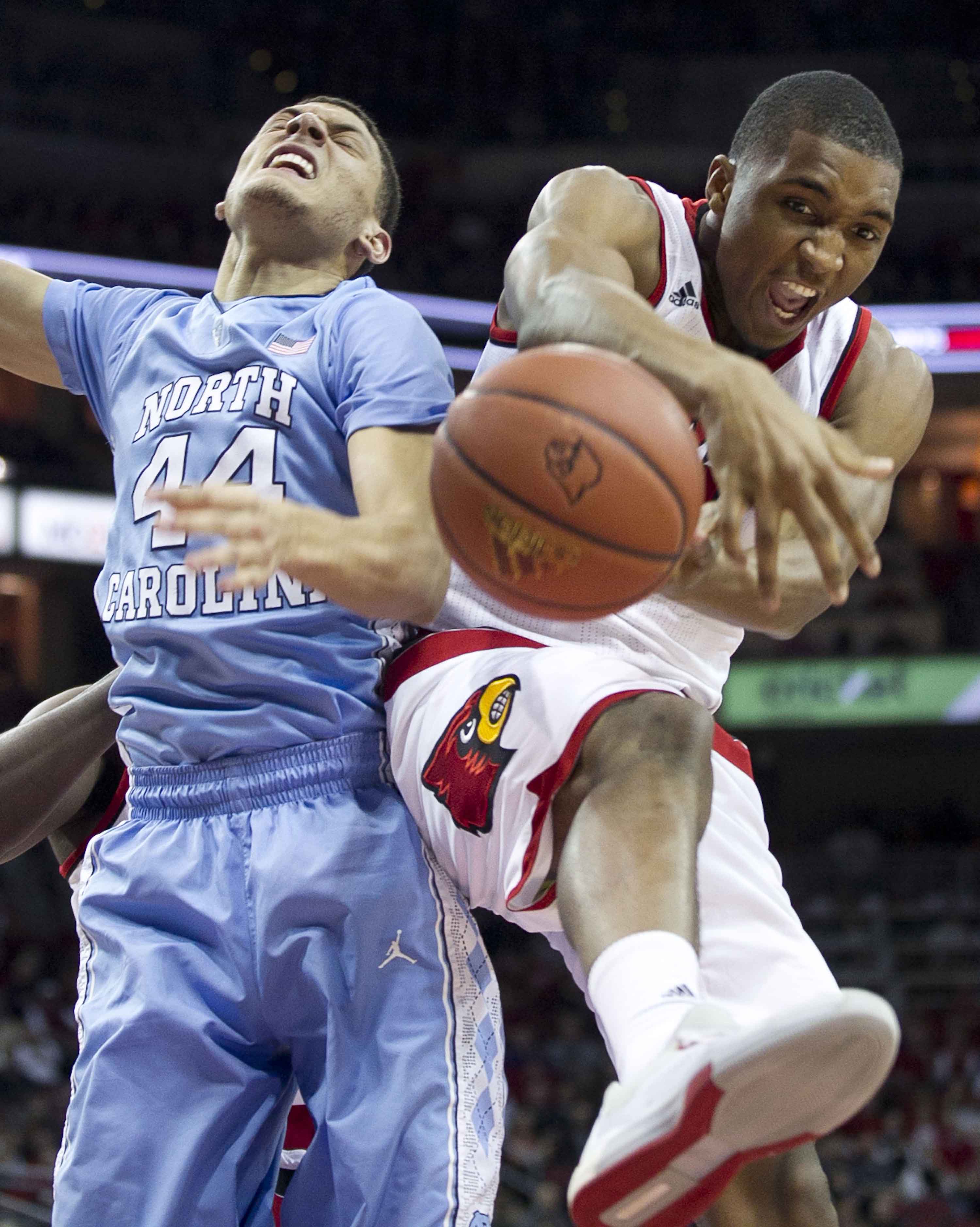 Louisville's Donovan Mitchell (45) secures a defensive rebound from North Carolina's Justin Jackson (44) during the second half on Monday, Feb. 1, 2016, at the KFC Yum! Center in Louisville, Ky. (Robert Willett/Raleigh News & Observer/TNS)