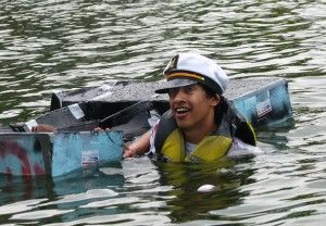 Edgar Orozco, a freshman from Elgin studying civil engineering, takes a swim in Campus Lake after his boat capsized in Saturday's 39th annual Cardboard Boat Regatta. After sinking almost immediately, Orozco was awarded the 