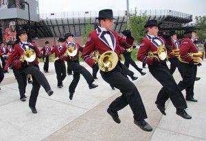 Jacob Gorecki, center, a freshman from Carbondale studying music, dances in parade formation Saturday during a pep rally before SIUs first home football game at Saluki Stadium. Gorecki plays mellophone in the SIU Marching Band and said he was excited to perform at the seasons first game.Sarah Gardner
