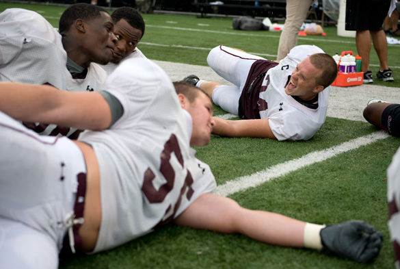 Senior outside linebacker Tyler Williamson, right, laughs with teammates Saturday after the final scrimmage at Saluki Stadium. Williamson, a captain of the Saluki football team prides himself in his leadership position. I am constantly talking to the younger guys, Williamson said.Nathan Hoefort • Daily Egyptian