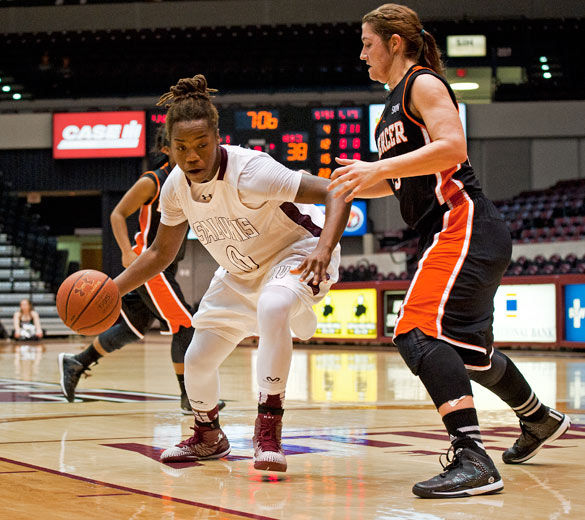 Then-junior center Dyana Pierre drives past Mercers Madi Mitchell on Nov. 30, 2014, during the second half of the Salukis 67-52 win at SIU Arena. (Lewis Marien | dailyegyptian.com)