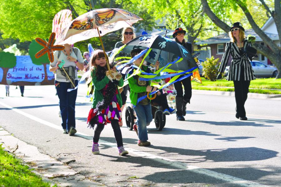 People with costumes and puppets march down North Glenview Drive in 2015 during the second All Species Puppet Parade in Carbondale. The focus is to raise awareness of the necessary coexistence of species. Lisa Barnes, a Beloved Puppetista and a local artist, said one goals of the All Species Puppet Parade is to show kids the relevance of having a sustainable earth. 