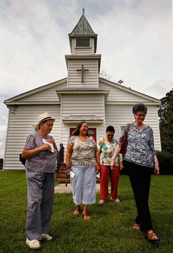 Joyce Krigsvold, right, Irene Hill, back, and Ann Wallace, center, members of the Pamunkey Church, located on the reservation, gather outside after Sunday worship on July 10, 2015 on the Pamunkey Reservation in Virginia. The church is designated the oldest Native American Church in Virginia. The Pamunkey Indian tribe has just received recognition from the U.S. government more than 450 years after signing their first treaty with the king of England. 