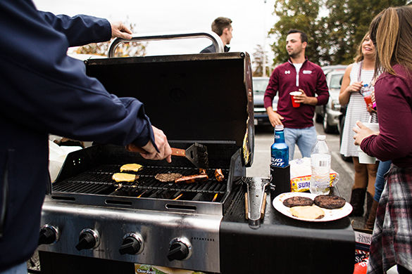 Bob Hardwick grills Saturday during the SIU homecoming tailgate. Hardwick, a 1978 SIU School of Law alumnus and current circuit court judge, comes back to SIU for homecoming every few years. 