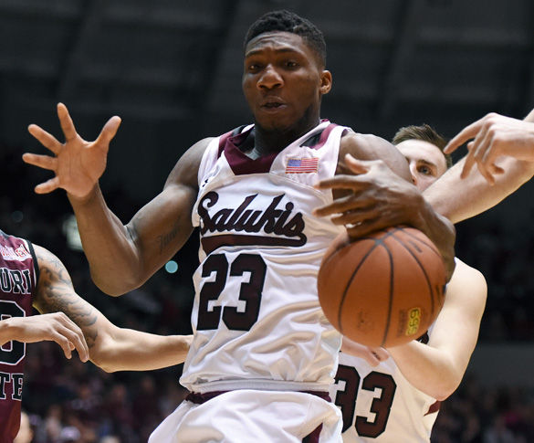 Junior center Bola Olaniyan attempts to grab the ball during SIU’s 78-68 victory against Missouri State on Feb. 27 at SIU Arena. Olaniyan scored 13 points and had 13 rebounds in the game.