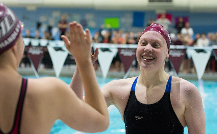 SIU+Freshman+swimmer+Kelsie+Walker+high+fives+teammate+Bryn+Handley+on+Wednesday+at+the+Edward+J.+Shea+Natatorium+during+the+first+day+of+the+MVC+Swimming+and+Diving+Championships.+The+Salukis+finished+in+the+800+Yard+Freestyle+Relay+with+40+points+and+a+time+of+7%3A18.77.%C2%A0