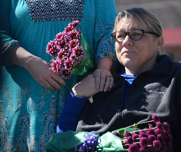Ida Evans holds the hand of her sister Teresa Collins during the four-year memorial of the Leap Day Tornado on Monday in Harrisburg. The tornado ripped through Harrisburg on Feb. 29, 2012, killing eight, including their 70-year-old father Donald Smith. “He was only conscious long enough to ask if my mom was OK,” Evans said. (Luke Nozicka | Daily Egyptian)