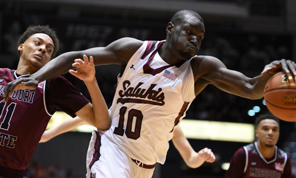 Senior center Ibby Djimde attempts to grab the ball during SIU’s 78-68 victory against Missouri State on Feb. 27 at SIU Arena. Djimde scored two points and had one rebound in the game.