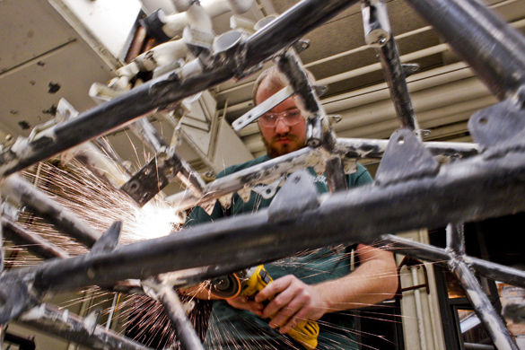 Jacob Strutner, a sophomore from Farmer City studying mechanical engineering, and the vice president of the SAE Saluki Baja club, cuts off the old suspension mounts from the front of last years racer to make room for the new mounting points Monday in a workshop in the Engineering D building. The group is building its racer to compete in the SAE Baja, or Society of Automotive Engineers Baja, series that will be held in Cookeville, Tenn., from April 14 to 17.  During the competition last year, the team came in 53rd. Hopefully we do better than last year, Strutner said. It wasnt what we were hoping for in a competition. 