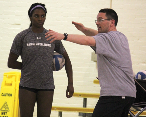 Junior middle hitter Kolby Meeks, a transfer from the University of South Alabama, watches as head coach Justin Ingram demonstrates how to serve during practice Monday, Feb. 1, 2016, in Davies Gym. Meeks said she transferred to SIU because she wasnt playing as much as she wanted to at South Alabama and felt she had a better chance playing here with a great team and coach. Were excited to have her, said Ingram. I think she fits in great with the group of girls we have right now. Our team is very welcoming and doing a good job making sure she fits in.