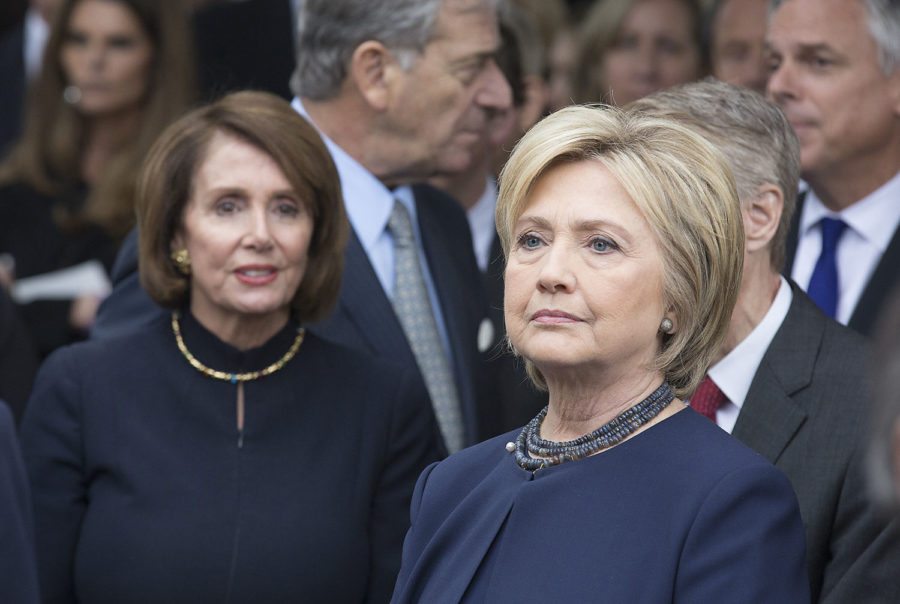 Hillary Clinton, right, and Nancy Pelosi, left, wait to pay respects with Reagan family members at Nancy Reagans gravesite at the Ronald Reagan Presidential Library in Simi Valley, Calif., on March 11. (Chicago Tribune)