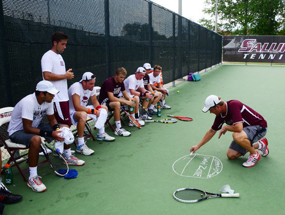 Then-SIU mens tennis coach Dann Nelson draws a diagram for his players Sept. 17, 2013 during practice at University Courts. (Daily Egyptian file photo)