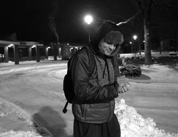 Alex Martinez, a freshman on the SIU swim team from Gilbert, Ariz., studying mechanical engineering, holds a handful of snow Jan. 20 on his way to morning practice. Martinez said it was the most snow he had ever seen. It’s more powdery than I expected, he said, and less icy. He said SIUC was appealing because of the difference in climate from his hometown and the swim team. (Morgan Timms | @morgan_timms)