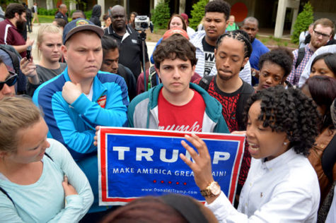 Supporters of Republican presidential candidate Donald Trump converse with SIU freshman MiKala Barrett on Monday outside Faner Hall following the May 2 protest. One of the issues addressed in the protest was racism at SIU, much of which has concerned the controversial presidential candidate. — May 2, 2016, Carbondale, Ill.