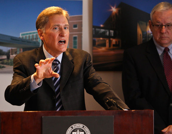 SIU President Randy Dunn speaks about Illinois budgetary issues and how they will affect the university while Carbondale Mayor Mike Henry looks on at a press conference held in the Stone Center. (Image by The Daily Egyptian)