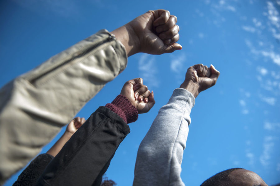 Protesters raise their fists to celebrate Tim Wolfes resignation during the Concerned Students 1950 protest on Monday, Nov. 9 2015, in Columbia, Mo. (Michael Cali/San Diego Union-Tribune/TNS)