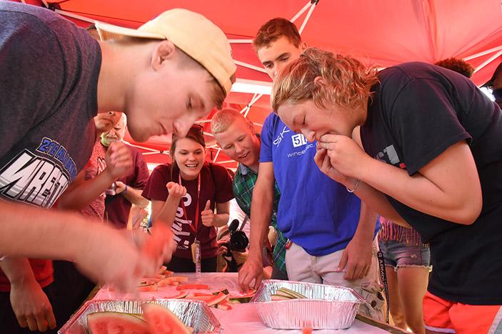 Students sink their teeth into slices of watermelon Sunday, Aug. 21, 2016, during Watermelon Fest in front of Morris Library. (Athena Chrysanthou | @Chrysant1Athena)
