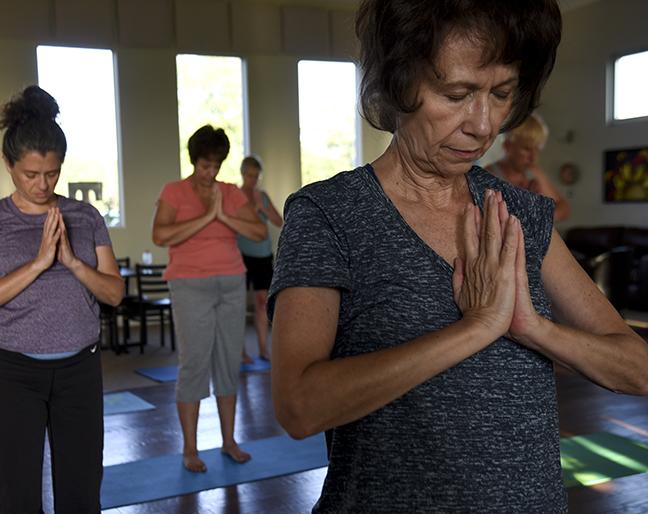 Pam Janes, of Makanda, performs the “heart-to-center” yoga pose Wednesday, Aug. 24, 2016, during Kelsey Tripp’s Wine & Yoga class at Alto Vineyards in Alto Pass. “I’ve noticed my body becoming more flexible and stronger,” Janes said. “We repeat the poses so you really see improvement.” (Autumn Suyko | @AutumnSuyko_DE)