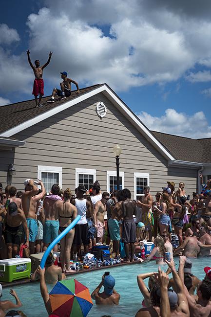 Solar Bear partygoers prepare to jump off a roof into the pool Saturday, Aug. 27, 2016, at The Reserve at Saluki Pointe. (Branda Mitchell for DailyEgyptian.com)