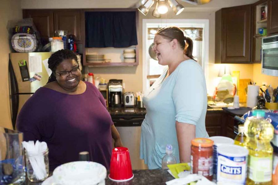 From left, Dawnn Pirani-Brumfield, 38, and her wife Rachel Pirani-Brumfield, 37, laugh at each other while unpacking groceries in their home Tuesday, July 26, 2016, in Chicago. (Armando L. Sanchez/Chicago Tribune/TNS)