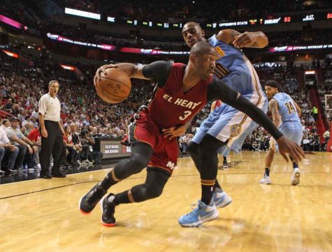 Miami Heat's Dwyane Wade drives against Denver Nuggets' Darrell Arthur during the first quarter on Monday, March 14, 2016, at AmericanAirlines Arena in Miami. (Hector Gabino/El Nuevo Herald/TNS)