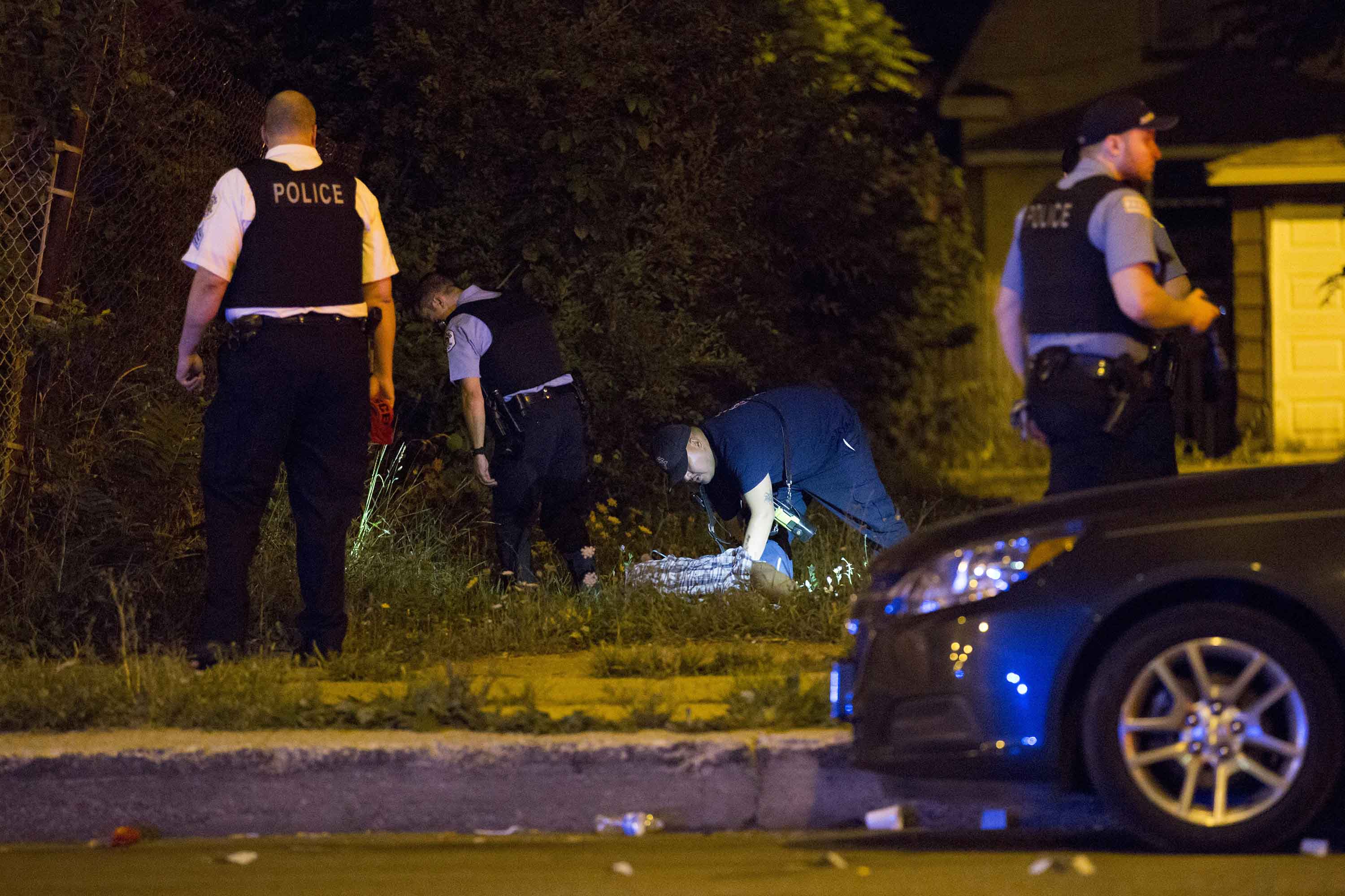 Members of the Chicago Police Department work the scene where two men were shot, one fatally, on the 6500 block of South Ashland Avenue Friday, Aug. 12, 2016, in Chicago. (Armando L. Sanchez/Chicago Tribune/TNS)