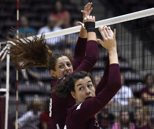 Junior outside hitter Andrea Estrada, left, and senior middle hitter McKenzie Dorris jump after attempting a block Saturday, Sept. 3, 2016, during SIU's 3-0 win over Western Michigan at SIU Arena. (Athena Chrysanthou | @Chrysant1Athena)