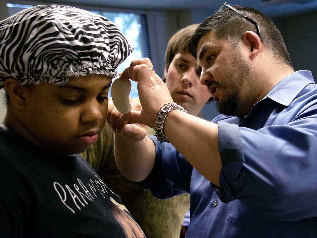 Mortuary Science Professor Abel Salazar identifies differences between a student’s clay ear and a student’s ear Monday, April 6, 2016, during a restorative art class at SIU. (Morgan Timms | @Morgan_Timms)