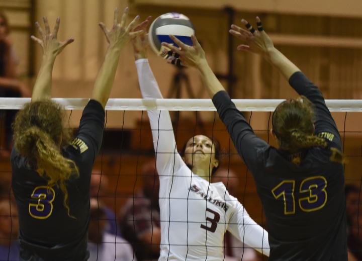 SIU senior setter/hitter Meg Viggars attempts to score past Northern Iowa senior outside hitter Amie Held (3) and senior middle hitter Kayla Haneline (13) during the Salukis 3-2 win over Northern Iowa on Friday, Sept. 23, 2016, at Davies Gym. (Athena Chrysanthou | @Chrysant1Athena)