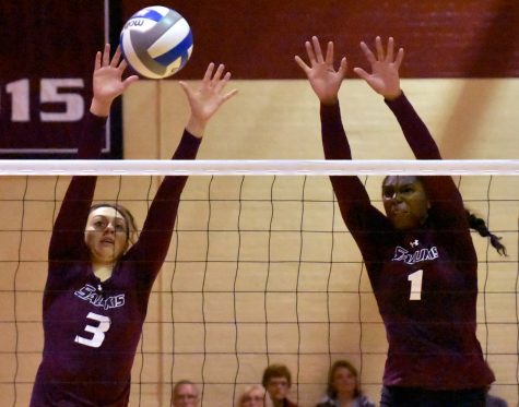 Senior hitter Meg Viggars, left, and junior middle hitter Kolby Meeks go for a block during SIU's 3-1 victory over the Drake Bulldogs on Saturday, Sept. 24, 2016, at Davies Gym (Sean Carley | @SCarleyDE)
