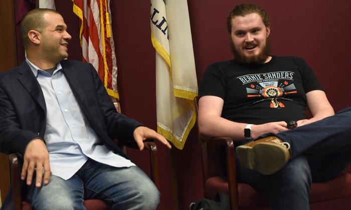 Senior staffers for Bernie Sanders' campaign and SIU alumni Tim Tagaris, left, and Zach Schneider, right, answer questions during “Pizza and Politics: Two Salukis for Bernie” on Tuesday, Sept. 27, 2016, at the Paul Simon Public Policy Institute in Carbondale. “Bernie doesn’t spend a lot of time joking,” Tagaris said. “Conversations with Sanders were generally very quick conversations — he’s a very busy man.” Tagaris said the coolest thing about working on the campaign was that Bernie proved anyone could run for president. (Autumn Suyko | @AutumnSuyko_DE)