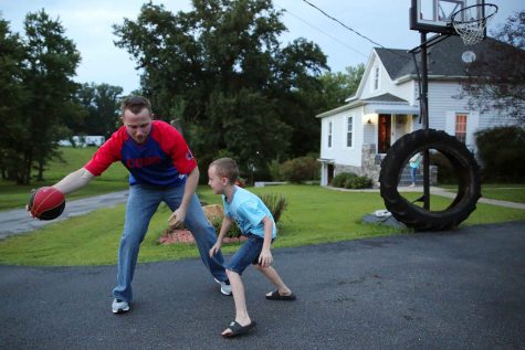 Coal miner Michael Tucker plays basketball with his son in the driveway of their home Wednesday, Aug. 31, 2016 in Equality, Ill. (Anthony Souffle/Chicago Tribune/TNS)