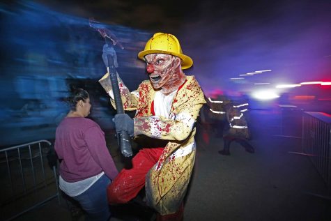Actors scare guests near a wrecked jet airliner in "Eli Roth Presents the Terror Tram" at the annual Halloween Horror Nights employee run-through on Sept. 13, 2016 in Hollywood, Calif. (Allen J. Schaben / Los Angeles Times)