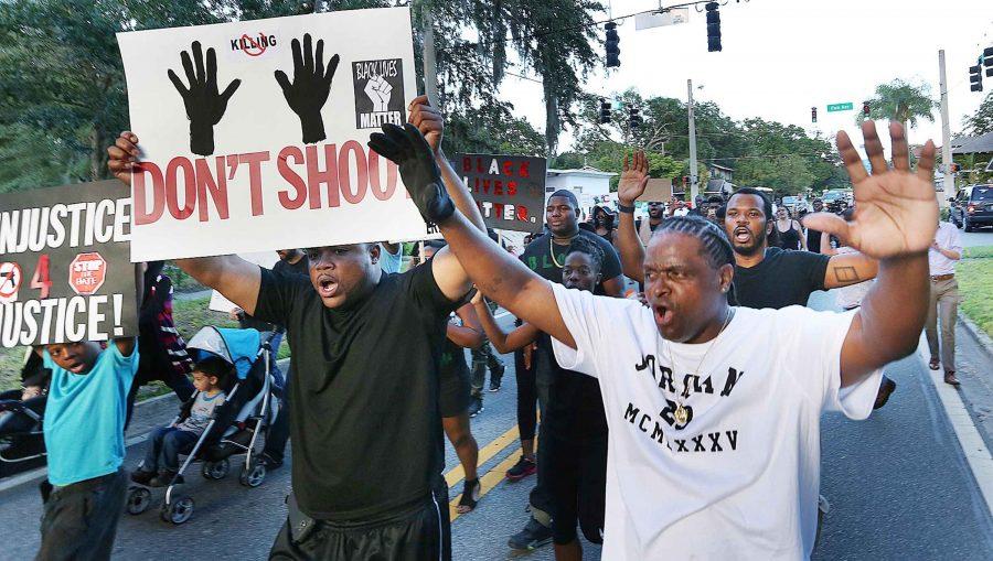 Marchers chant and carry signs in Sanford, Fla., during a Black Lives Matter march and rally on Sunday, July 17, 2016. (Stephen M. Dowell/Orlando Sentinel/TNS)